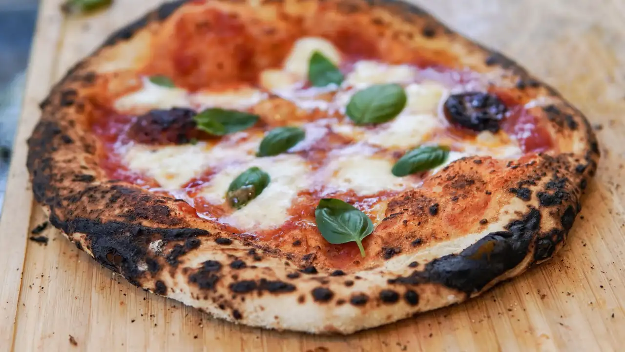 Wood-fired mushroom and herb pizza with golden bubbly cheese crust