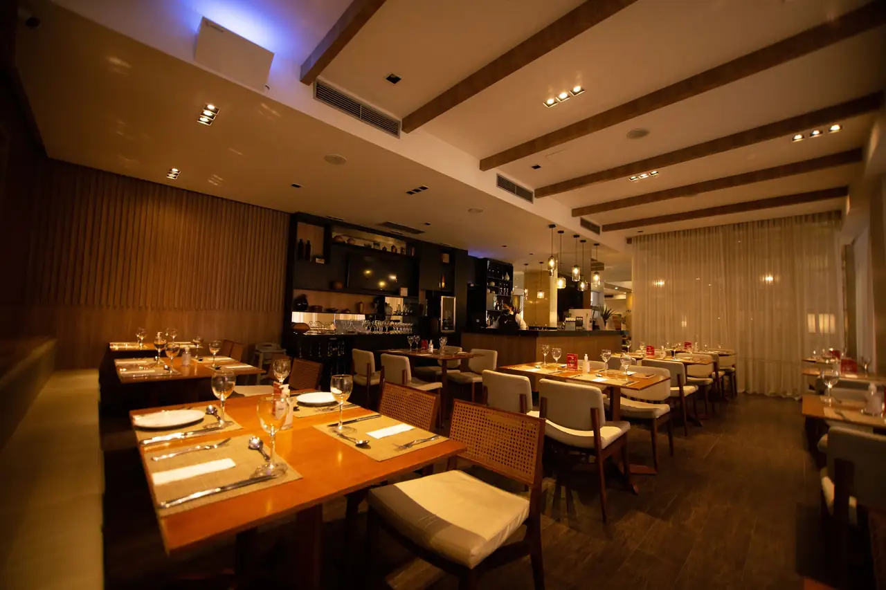 Sophisticated dining room interior with warm table settings at Koraven Thessique