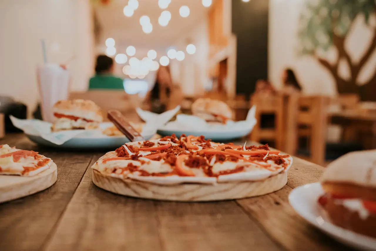 Freshly baked artisan pizza close up on a dark dining surface