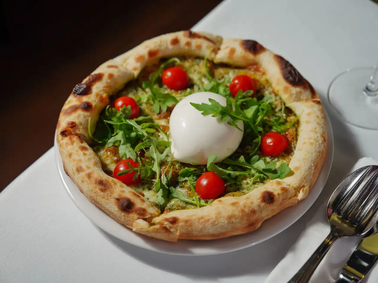 Quattro Formaggi with creamy burrata and herb garnish
