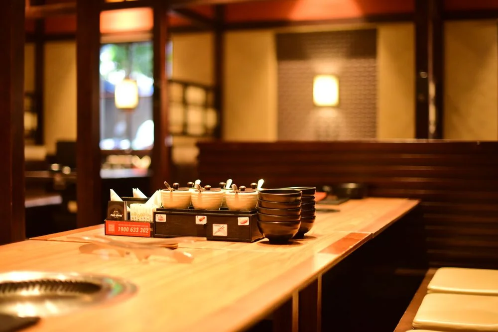 Warm restaurant interior with wooden tables and soft ambient lighting