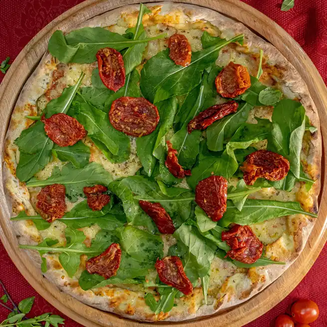 Mediterranean garden vegetable pizza with sun-dried tomatoes